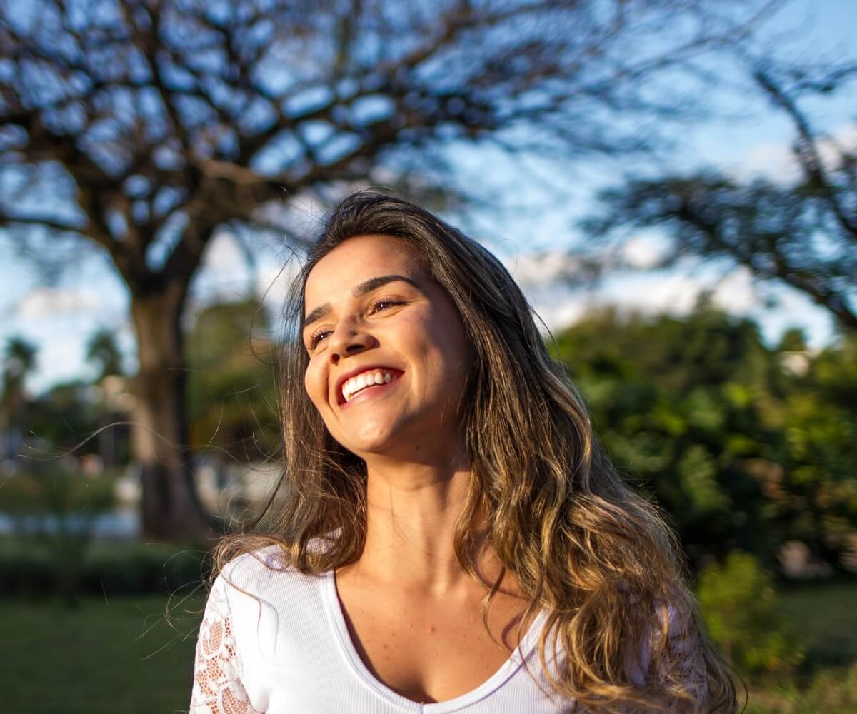 Woman smiling after cosmetic teeth whitening services in Erie, PA