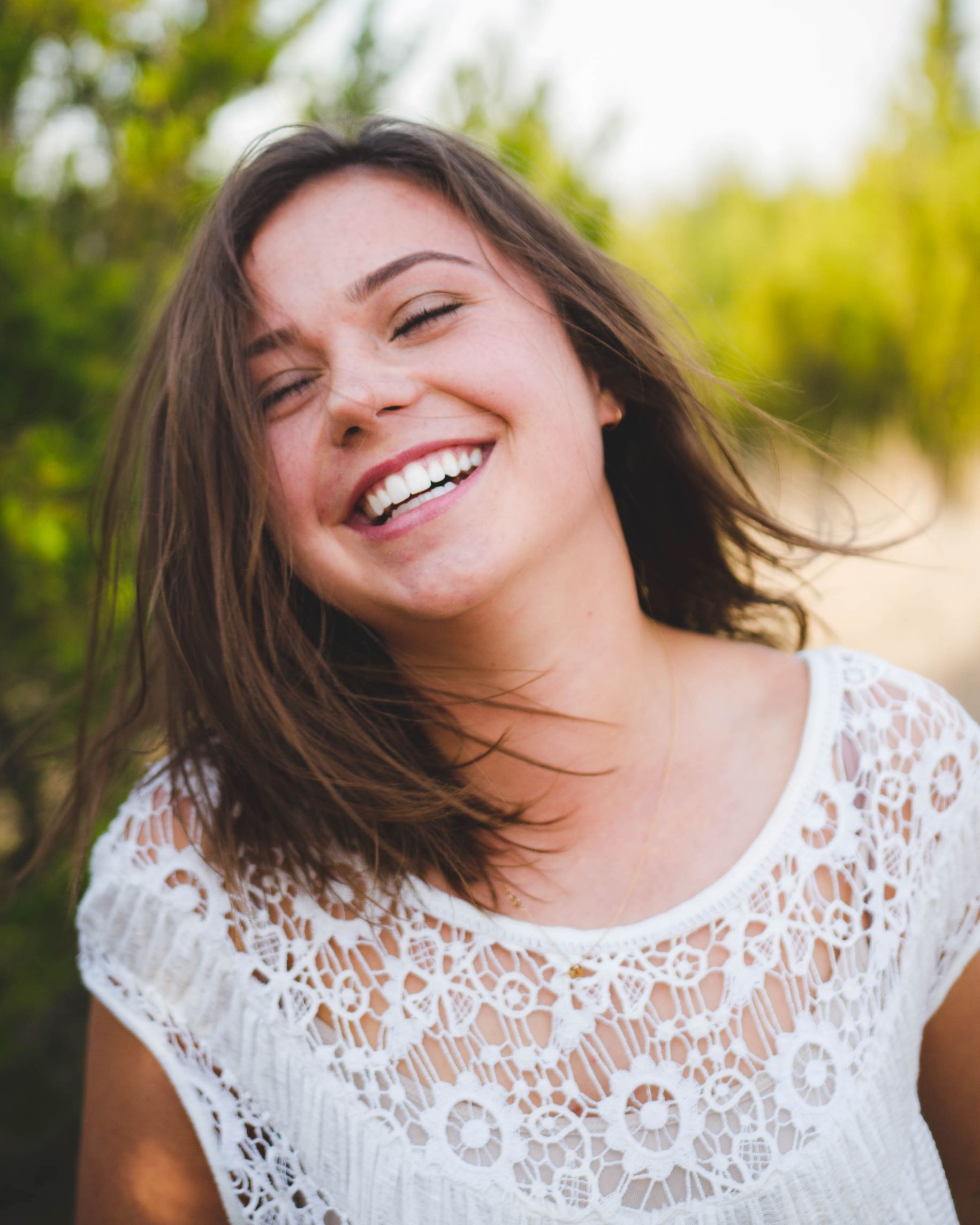 Photo of woman smiling after receiving a qualified second opinion about her dental condition